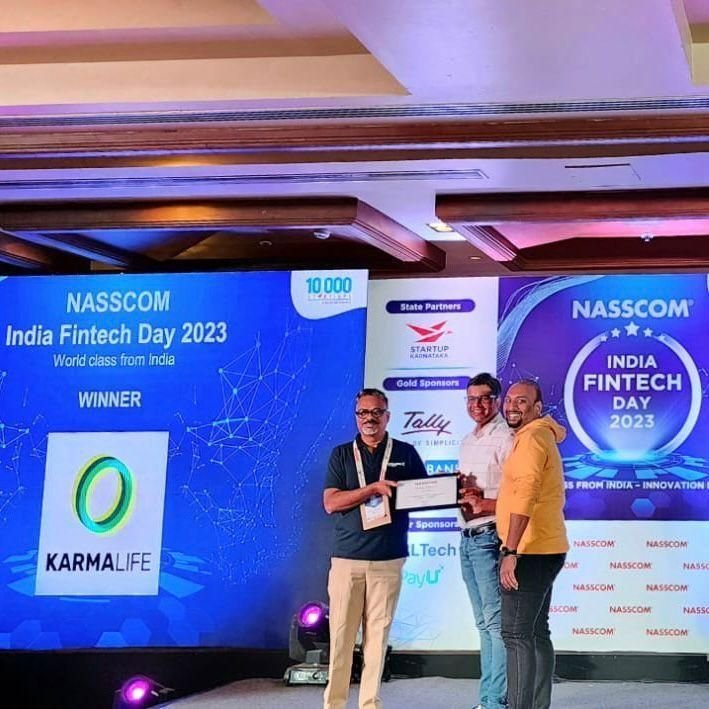 Naveen Budda on stage accepting the NASSCOM India Fintech Day 2023 award on behalf of KarmaLife.